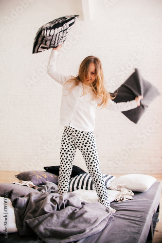 Little happy girl with pillows