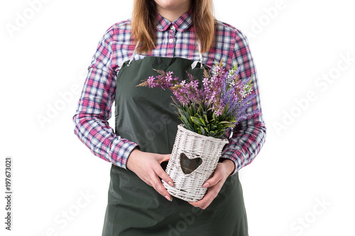 smiling woman professional gardener or florist in apron holding flowers in a pot isolated on white background