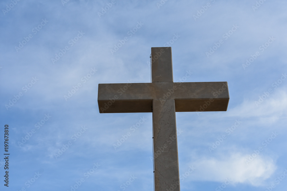 Catholic cross on the hills in Dubrovnik Croatia. Catholic symbol against blue sky 