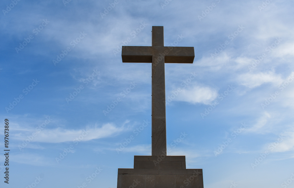 Catholic cross on the hills in Dubrovnik Croatia. Catholic symbol against blue sky 