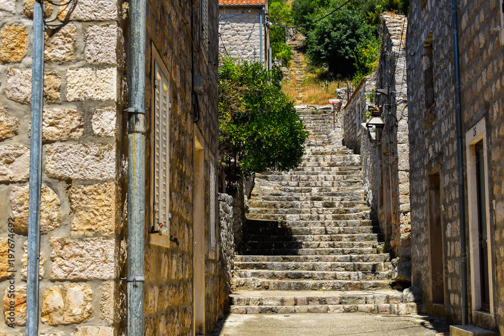 narrow romantic street between houses in small village in Ston Croatia 