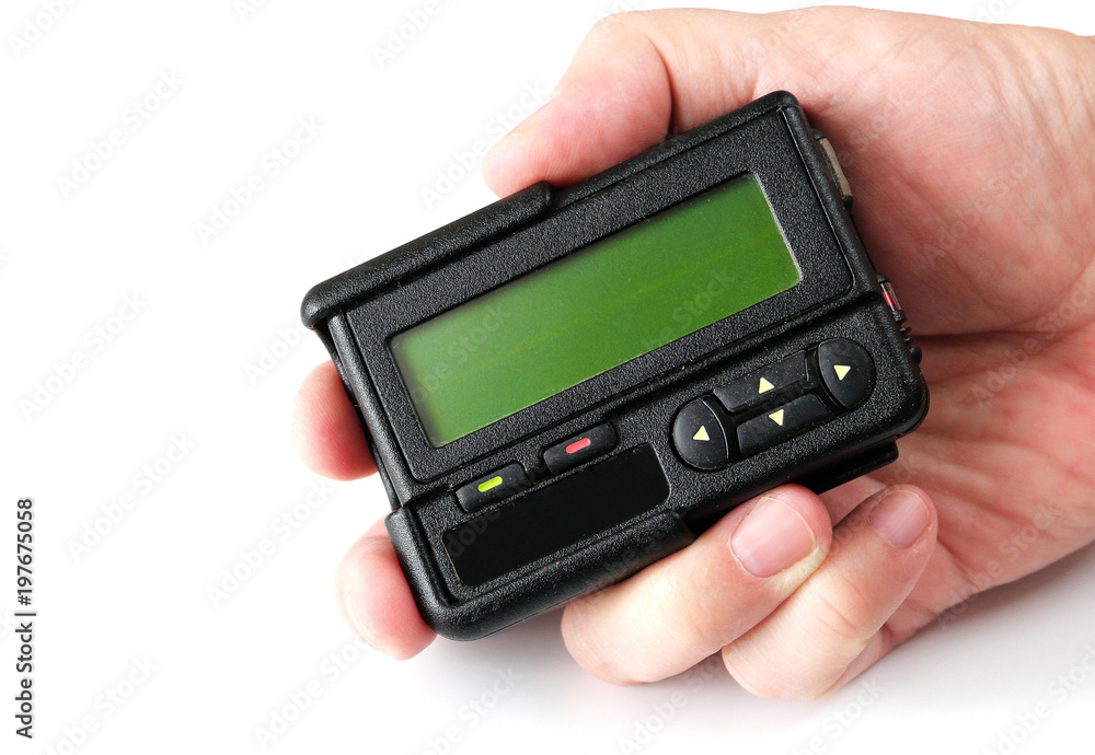 Old black pager in hand isolated on white background Old black pager in hand isolated on white background