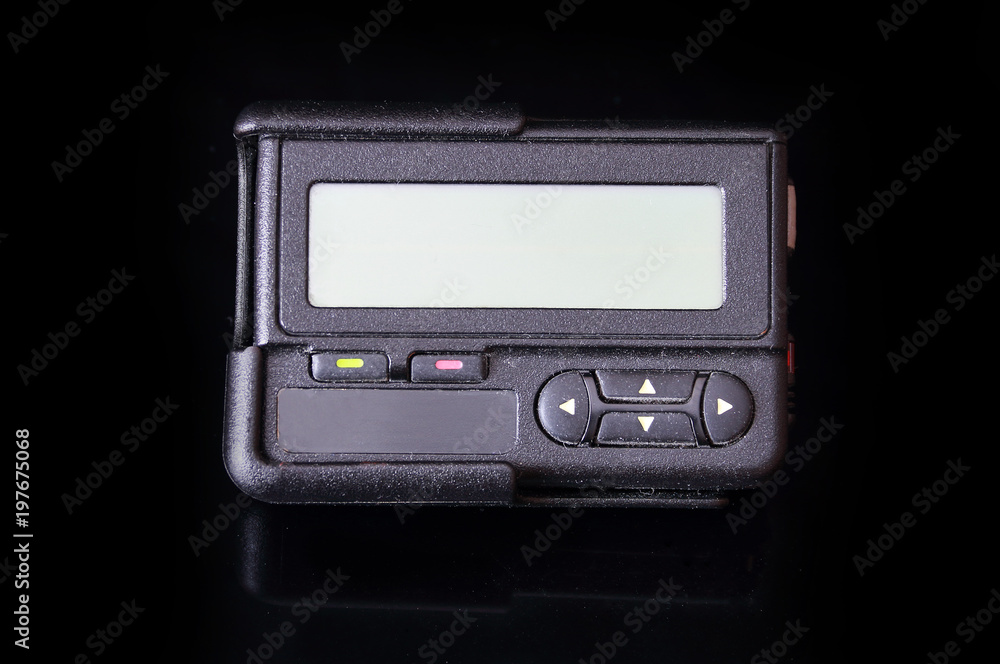 Fototapeta premium Old black pager isolated on black background