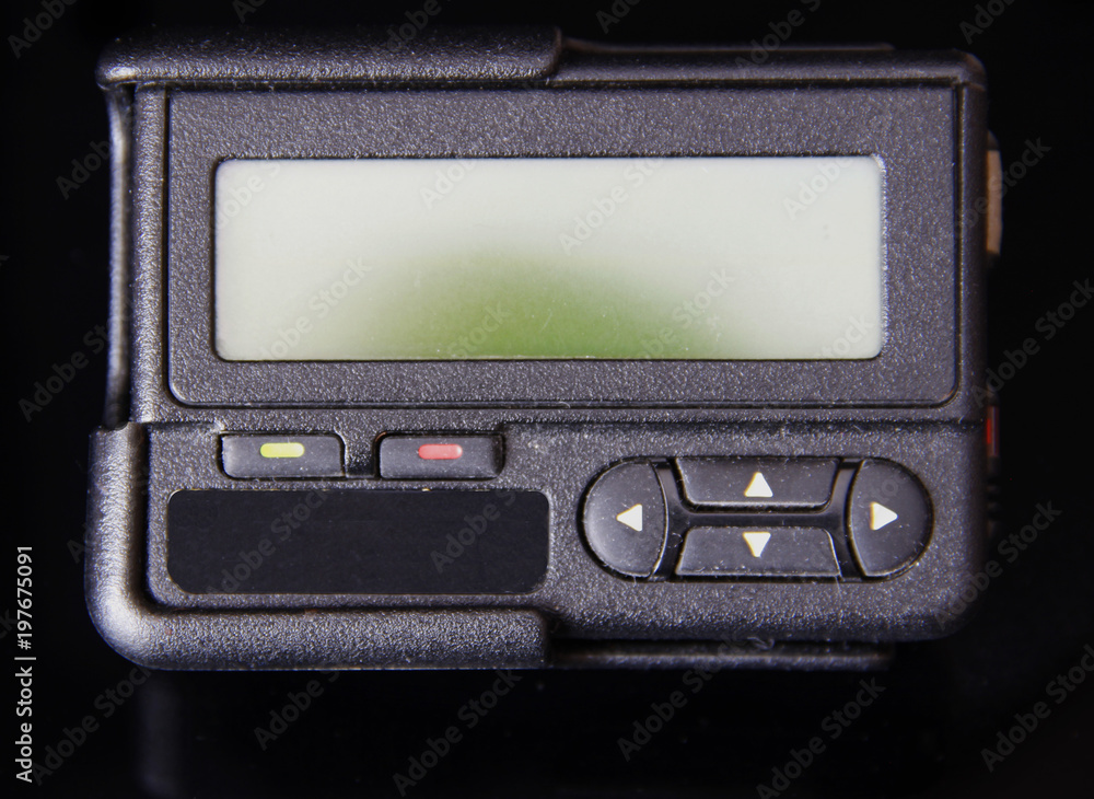 Fototapeta premium Black old pager or beeper isolated on black background