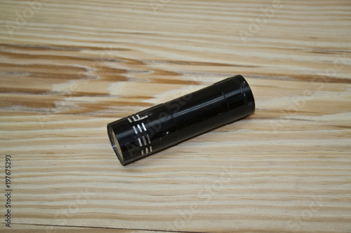 flashlight isolated on a wooden background