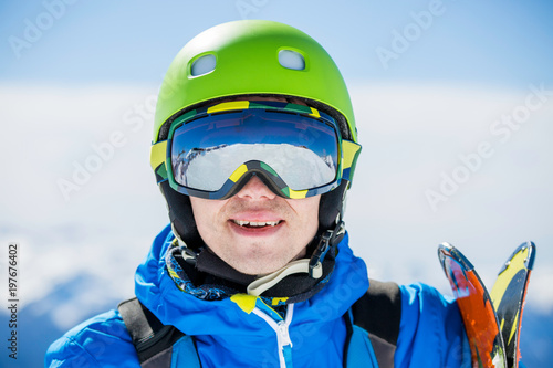 Portrait of sporty man with skis