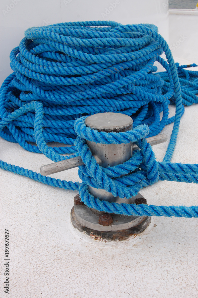 Fototapeta premium Blue rope on a white ship, mooring