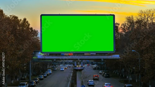 Wallpaper Mural A billboard with green chroma key on the background of fast moving cars at sunset Torontodigital.ca