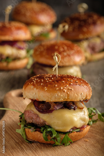 Homemade juicy burgers with beef, cheese and caramelized onions. Street food, fast food