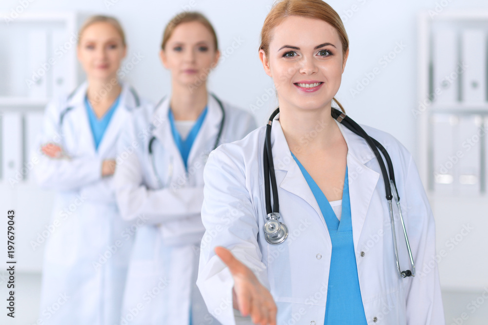Group of medicine doctors offering helping hand for shaking hand or saving life. Partnership and trust concept in health care or medical cure Group of medicine doctors offering helping hand for shaking hand or saving life. Partnership and trust concept in health care or medical cure