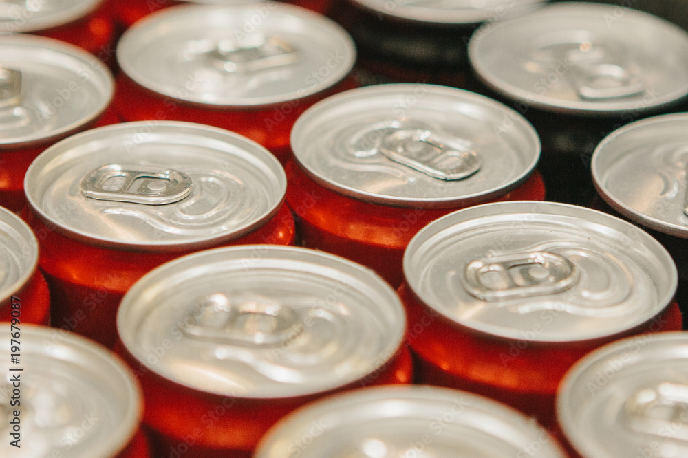 Many metal cans with cool drinks. A group of objects. Beverages Many metal cans with cool drinks. A group of objects. Beverages