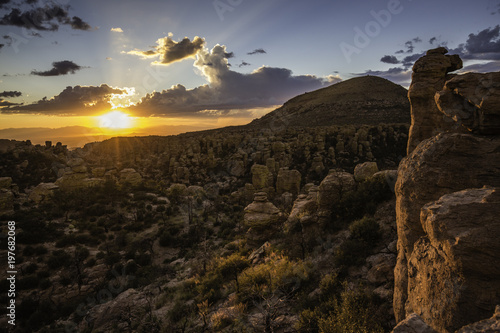 Pinnacles or hoodoos are visible at sunset at Chiricahua National Monument in Arizona, USA.