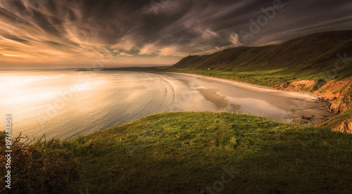 Sunset at Rhossili Bay on the Gower peninsula, Swansea, South Wales, UK, voted one of the top ten best beaches in Britain
