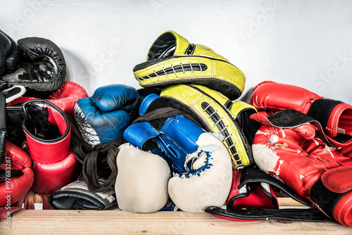 Set of worn boxing and kickboxing accessories: gloves, hand wraps, focus punch pad