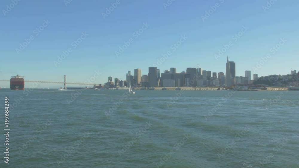 Boat and a cargo ship floating in San Francisco Bay Boat and a cargo ship floating in San Francisco Bay