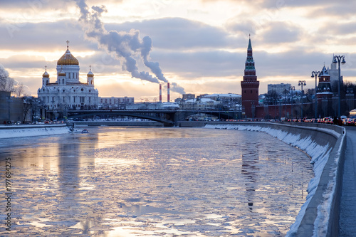 Kremlin and church in winter near river, ice