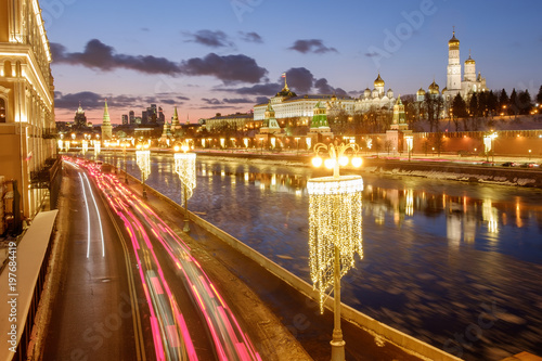 The Moscow Kremlin  a traffic jam  a frozen river  winter