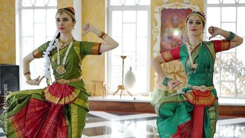 Two attractive girls in a sari dance a national dance photo