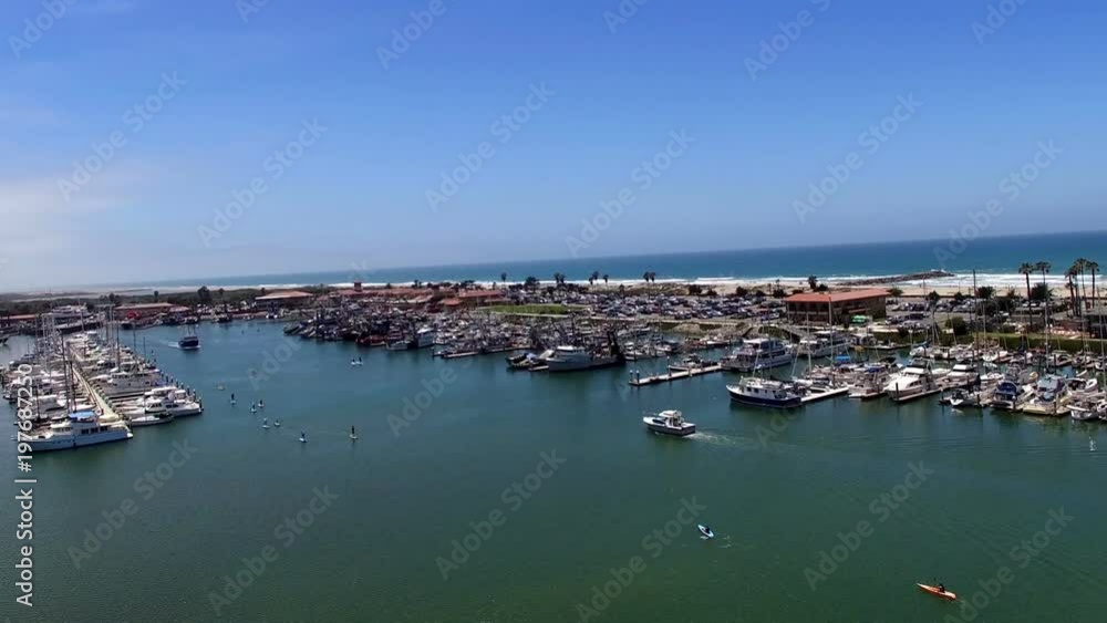 Aerial drone clip of boats and paddle boarders in marina Aerial drone clip of boats and paddle boarders in marina