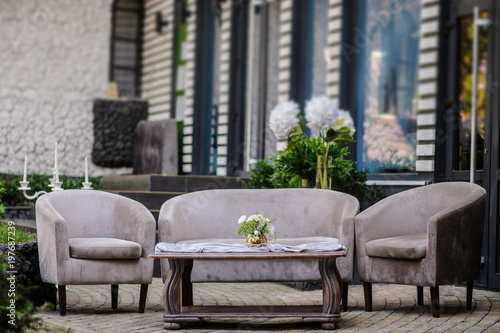 Outdoor composition from vintage sofa and armchair