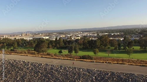 Aerial Drone clip of joggers on bike path at Hansen Dam in Los Angeles photo