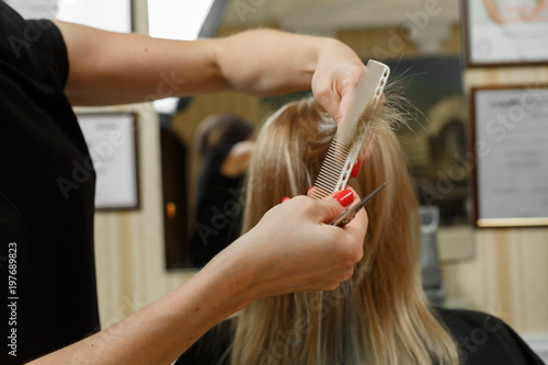 he process of hairstyles in the hairdressing salon fashionable modern women's haircut the process of laying hair lacquer hairdresser in the workplace