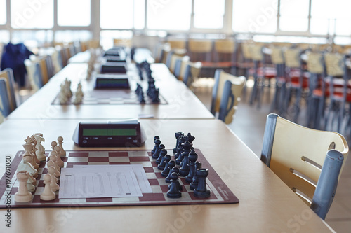 Chess tournament tables with chess timers and blank note papers
