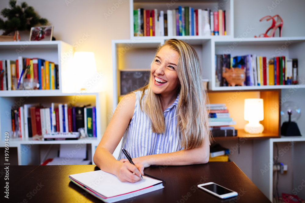 smiling young woman working in her home smiling young woman working in her home