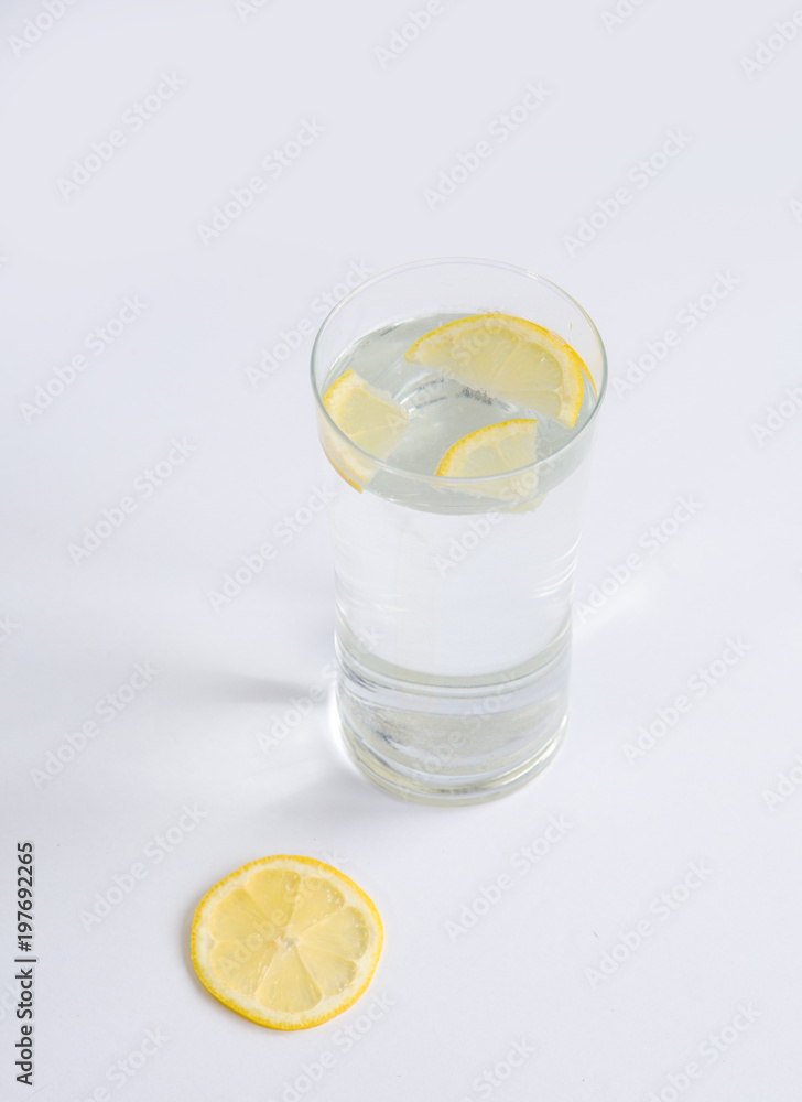Glass of water with lemon slices on a white background Glass of water with lemon slices on a white background