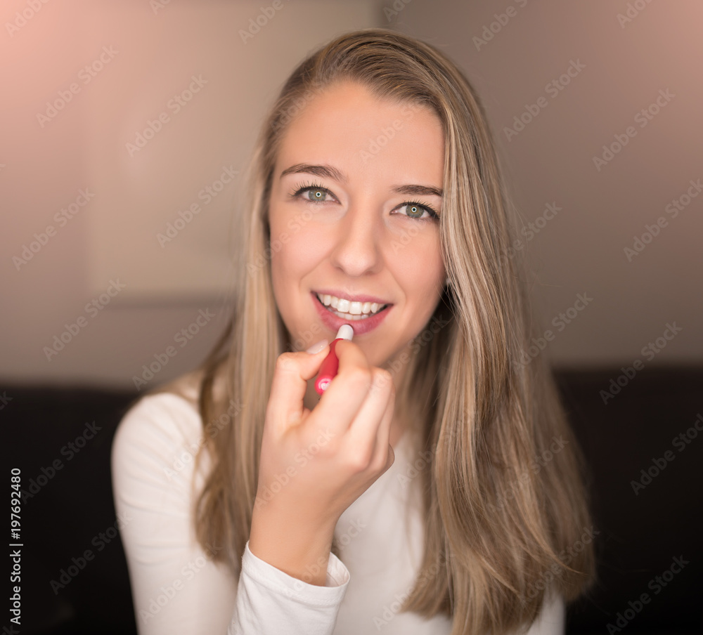 pretty blonde young woman applying her lip gloss, make up pretty blonde young woman applying her lip gloss, make up