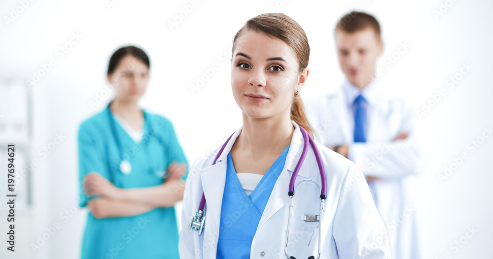 Attractive female doctor in front of medical group Attractive female doctor in front of medical group