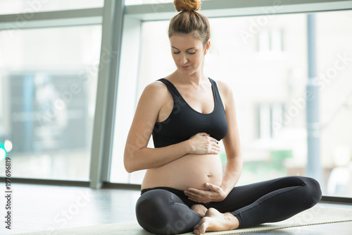 pregnant woman doing prenatal yoga