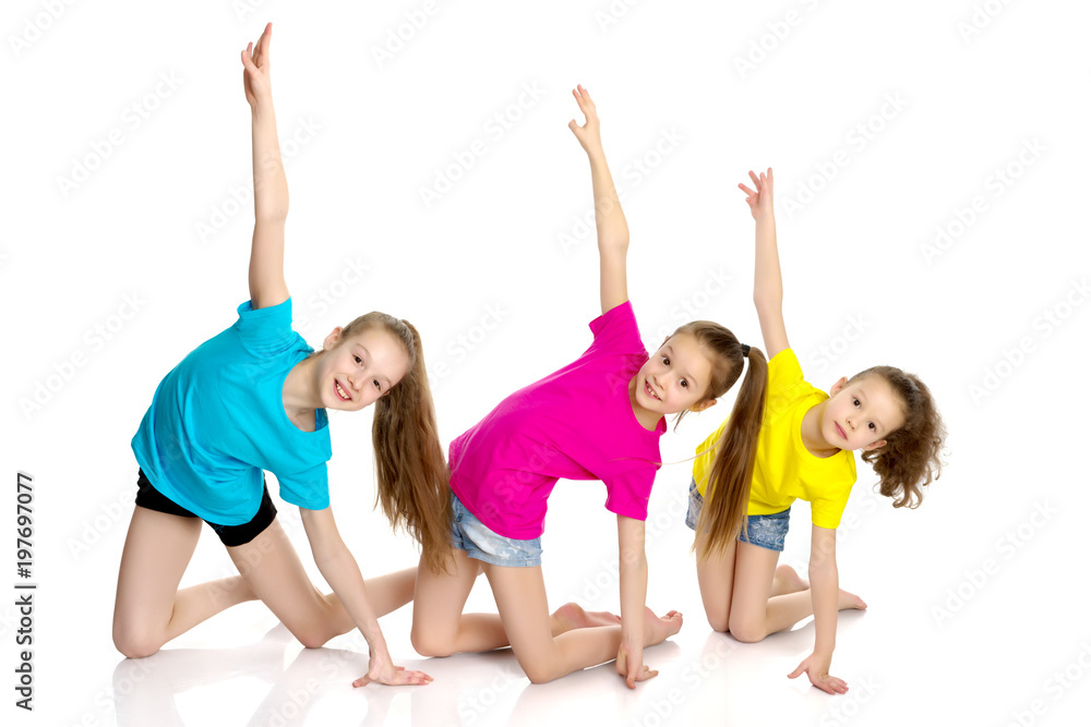 Naklejka premium A group of girls gymnasts perform exercises.