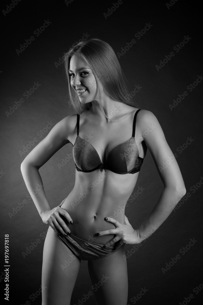 young sexy girl in underwear on a black background