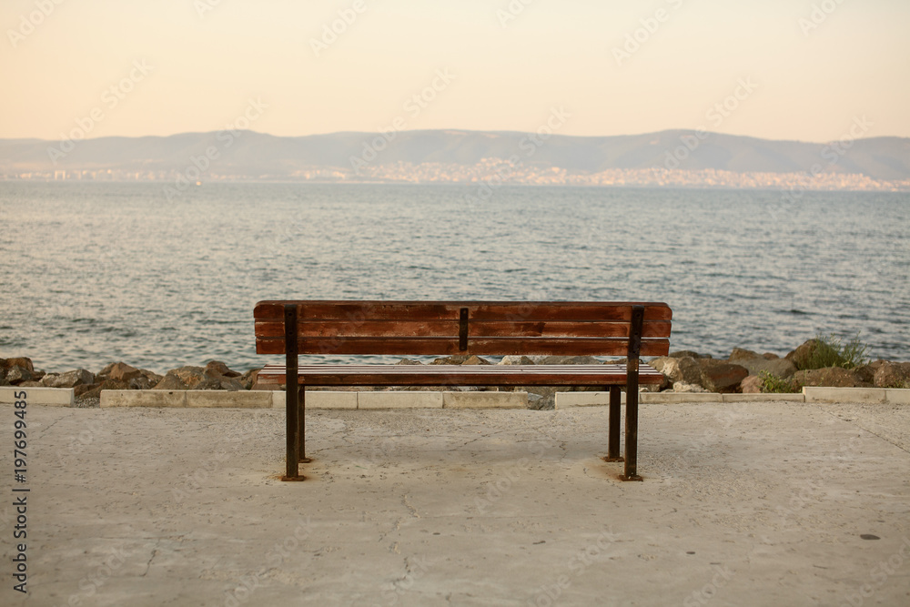 Wooden bench in front of the sea