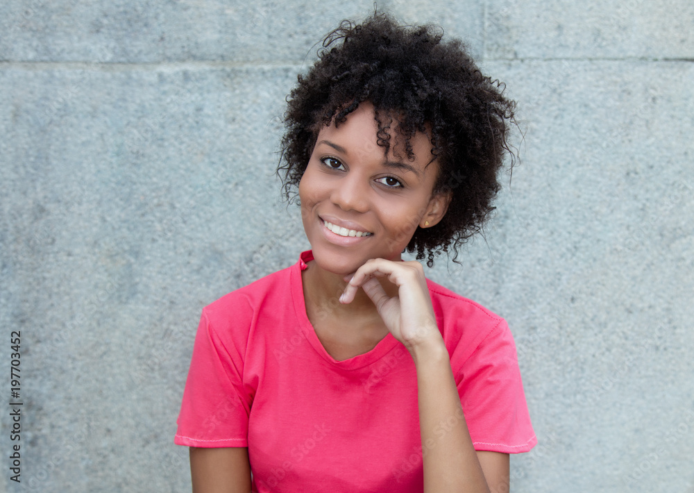 Laughing brazilian woman in bright red shirt