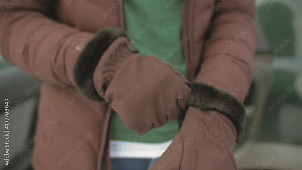 Close up shot of someone putting on some snow gloves Close up shot of someone putting on some snow gloves
