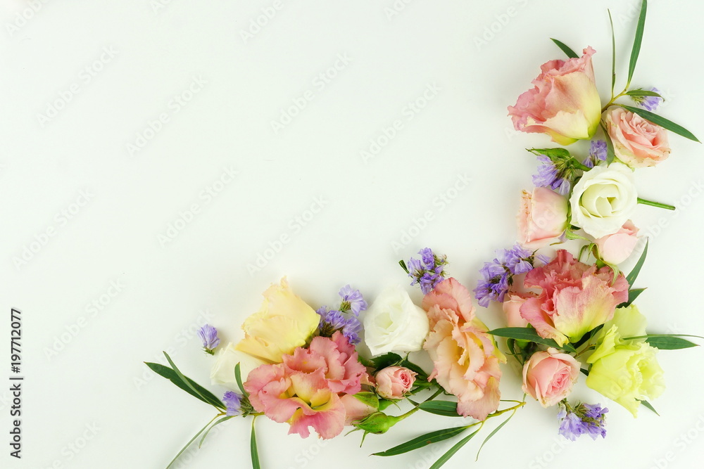 Flowers background. Wreath frame made of pink and purple flowers and eucalyptus branches on a white background. Flat lay. top view. copy space Flowers background. Wreath frame made of pink and purple flowers and eucalyptus branches on a white background. Flat lay. top view. copy space