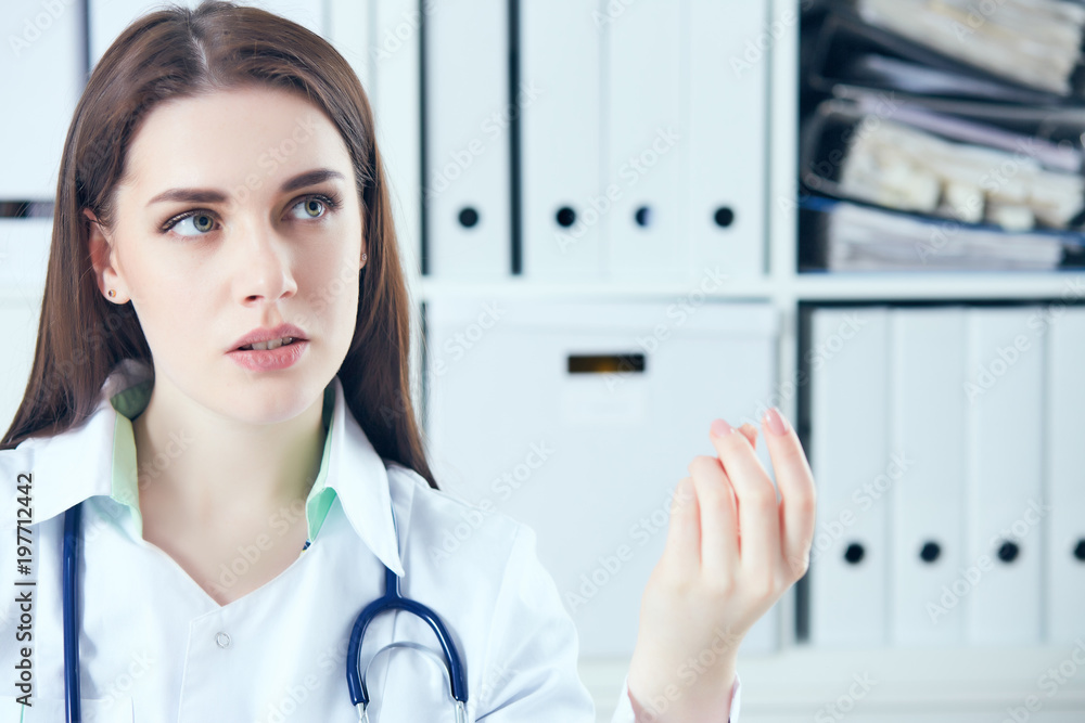 Young female doctor giving a consultation to a patient and explaining medical informations and diagnosis Young female doctor giving a consultation to a patient and explaining medical informations and diagnosis