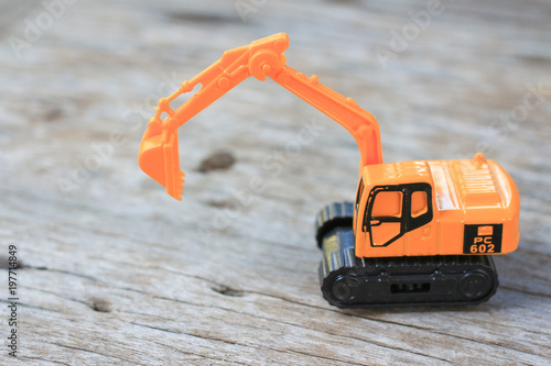 Dump toy truck Excavator machine toy yellow color on wooden © Luis2499