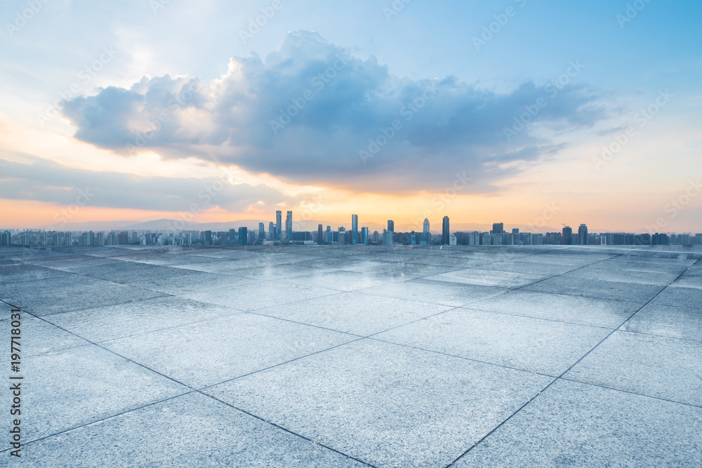 empty concrete floor and modern buildings in midtown of singapore in blue cloud sky