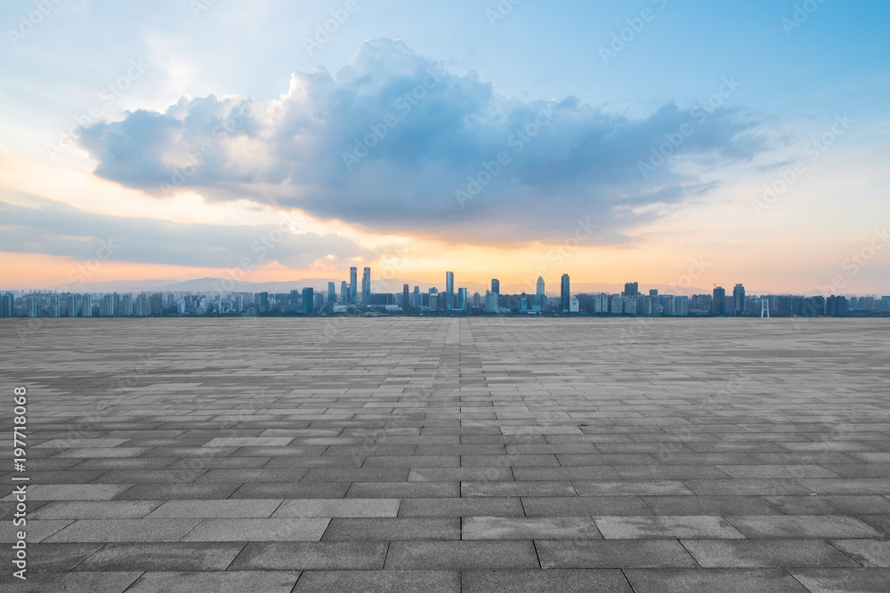 empty concrete floor and modern buildings in midtown of singapore in blue cloud sky