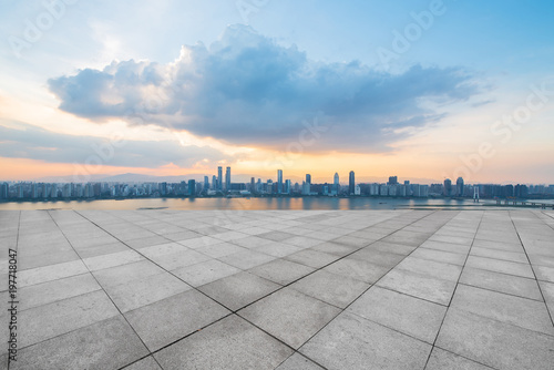 empty concrete floor and modern buildings in midtown of singapore in blue cloud sky © 安琦 王