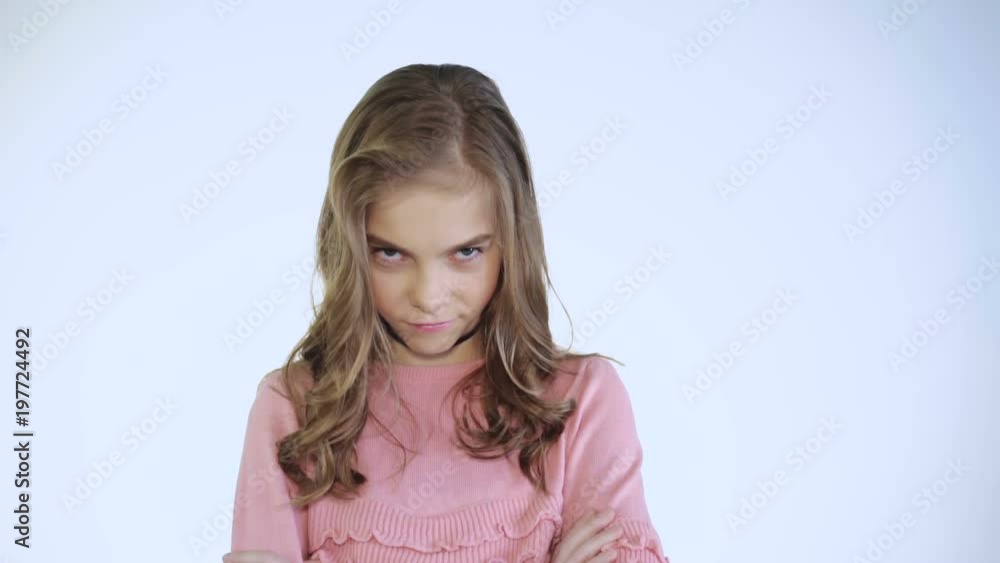 Portrait of sad offended girl looks at camera on background Portrait of sad offended girl looks at camera on background