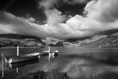 Black and white Landscape image of rowing boats on Llyn Nantlle in Snowdonia at sunset © veneratio