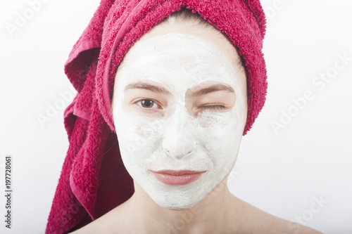 beautiful woman with face mask and creme winking