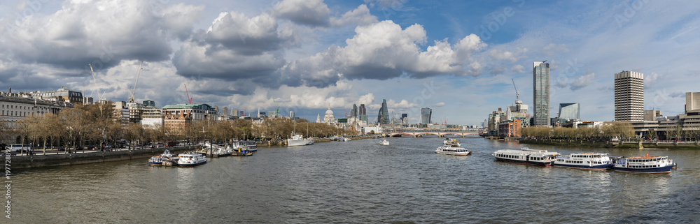 Beautiful landscape image view from Waterloo bridge along River Thames towards financial district in London