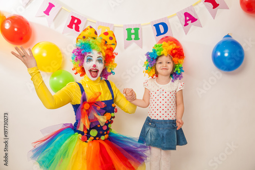 clown girl on the birthday of a child. A party for a child. A child in a clown wig