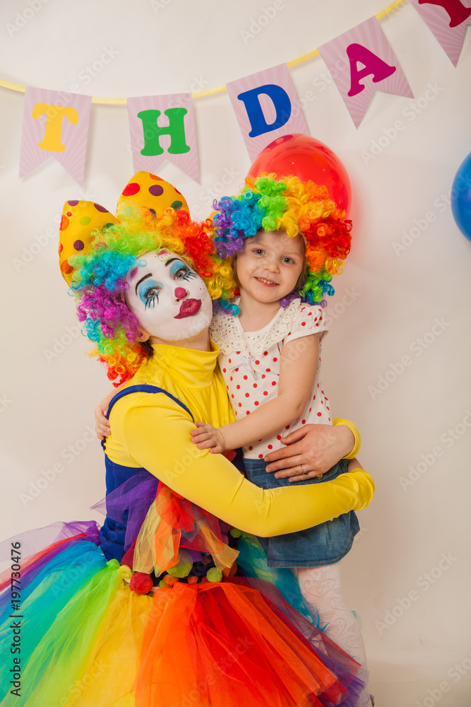 clown girl on the birthday of a child. A party for a child. A child in a clown wig