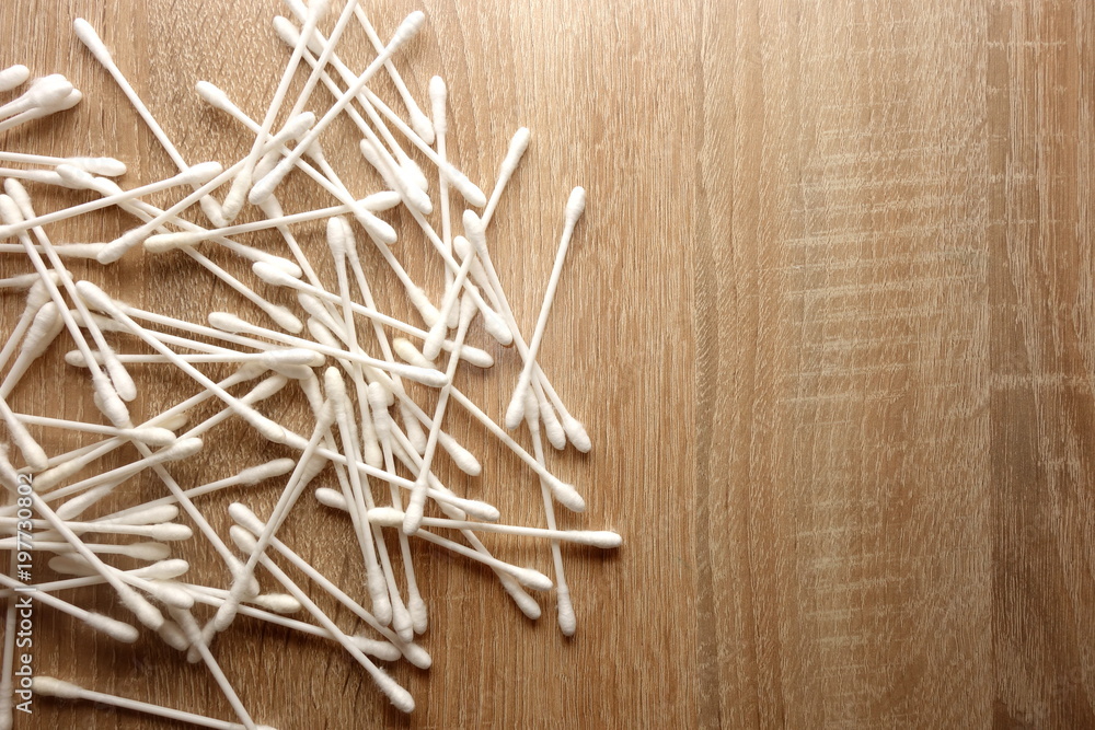 Cotton sticks on wooden background with copy space for your design